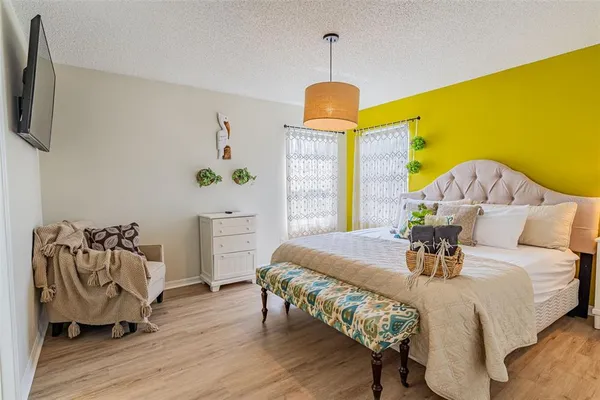 a bedroom with a bed and a flat screen tv