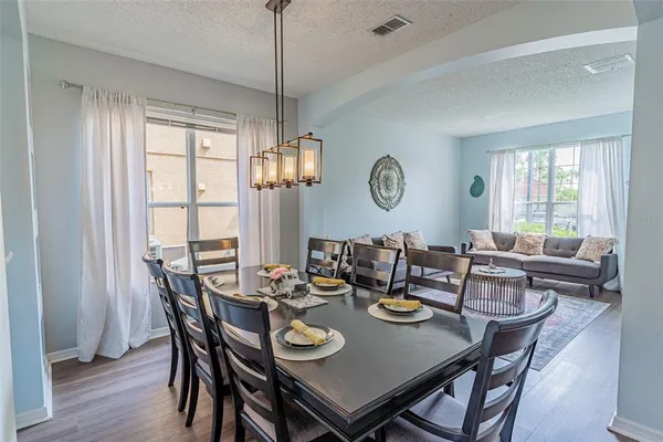 a view of a dining room with furniture window and wooden floor