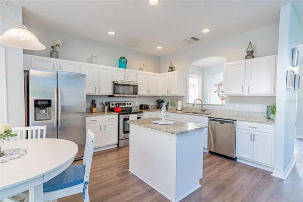 a living room with furniture a rug and a large window