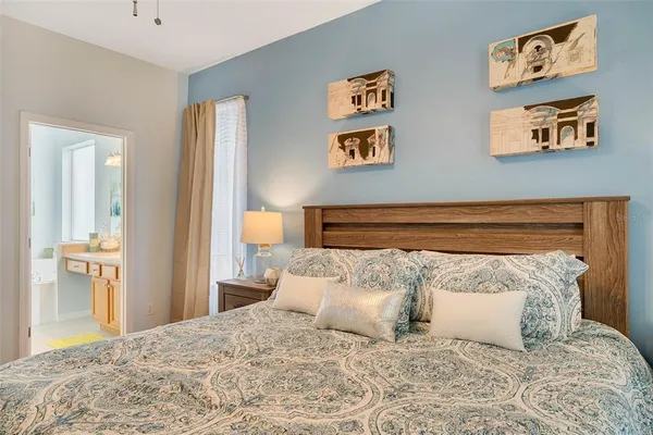 a view of a street with potted plants and large trees