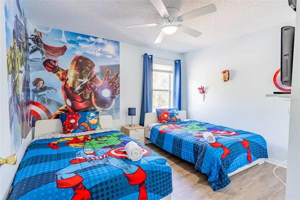 a bedroom with bed and wooden floor