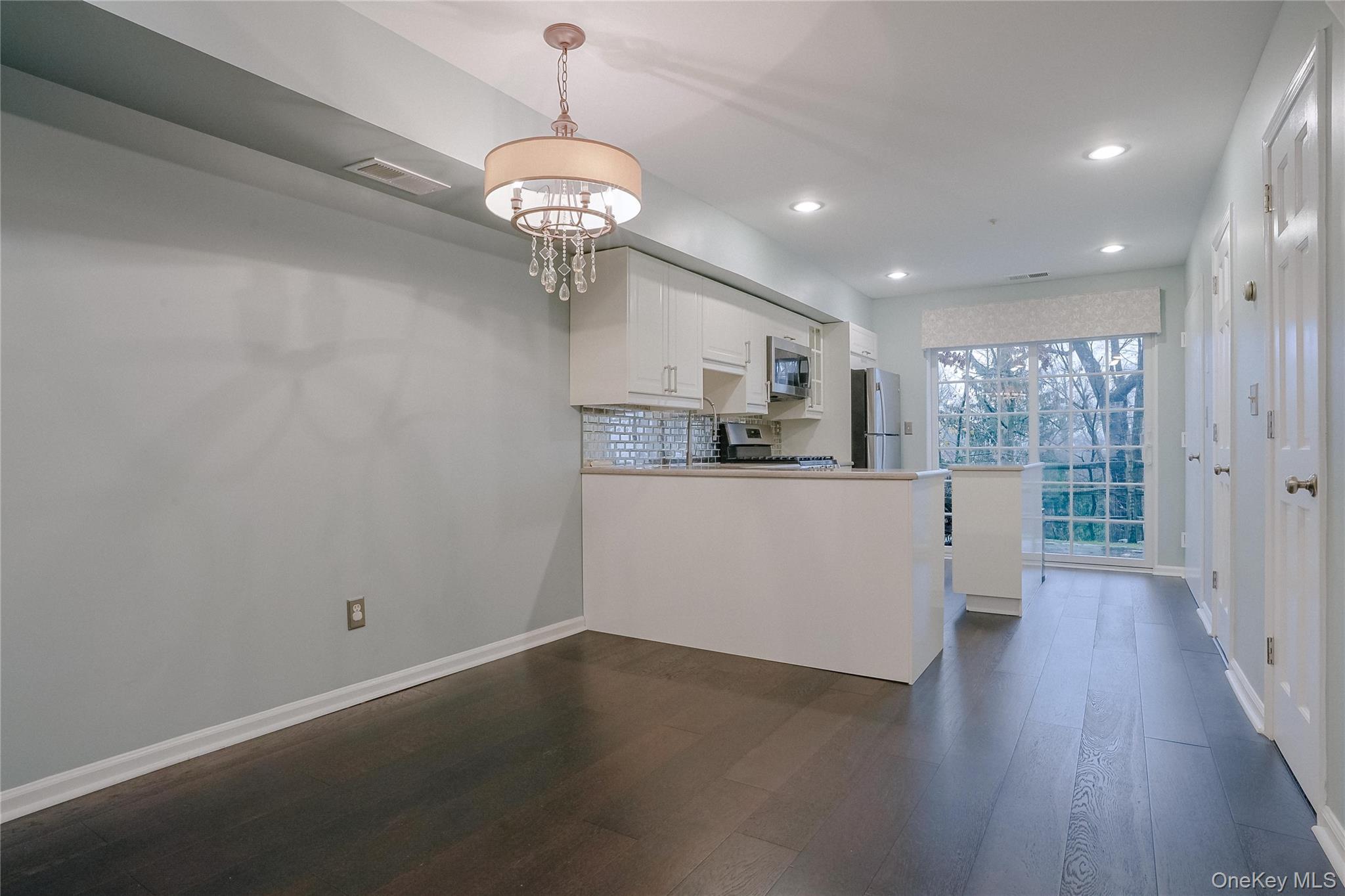 203 Park Ridge Lane White Plains, NY 10603 - Photo 18 of 30 a view of a kitchen with a sink wooden floor and a chandelier