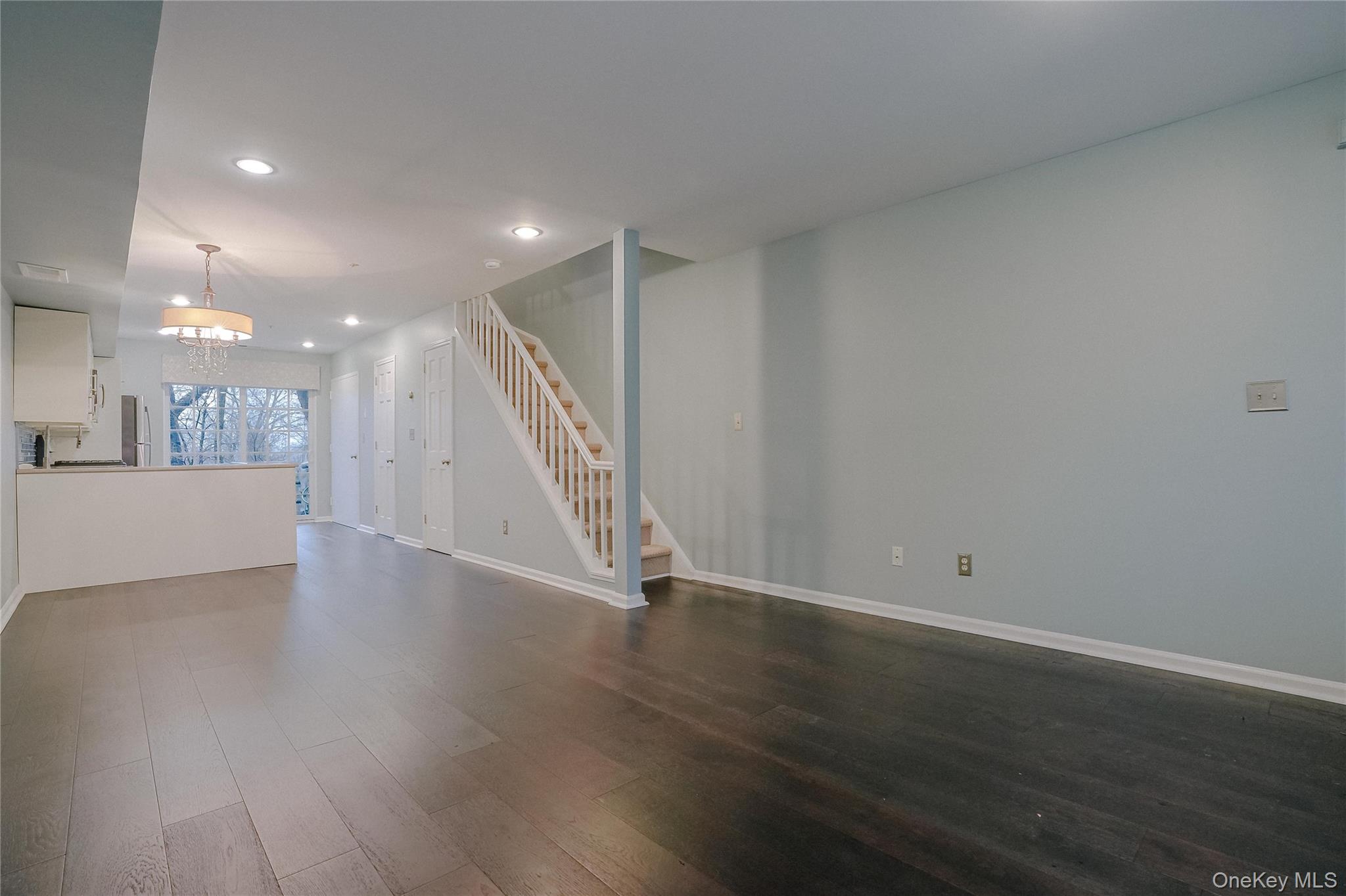203 Park Ridge Lane White Plains, NY 10603 - Photo 21 of 30 a view of an empty room with wooden floor and a kitchen