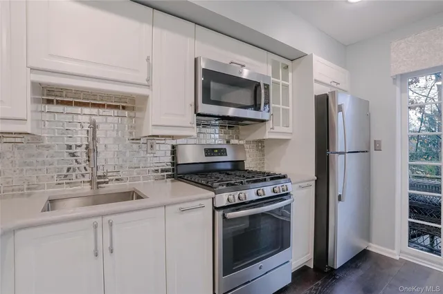 a kitchen with a stove a microwave and a counter top space