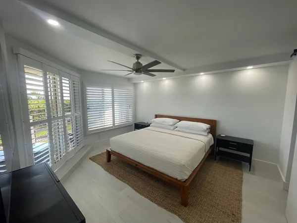 a spacious bedroom with a bed and a large window