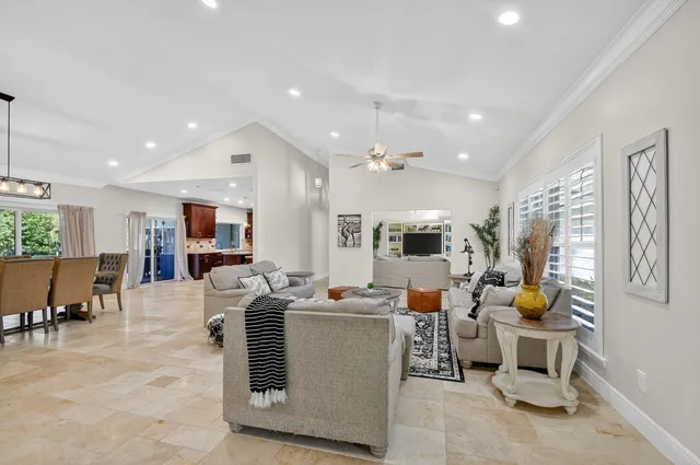 a kitchen with kitchen island granite countertop a sink counter top space appliances and cabinets