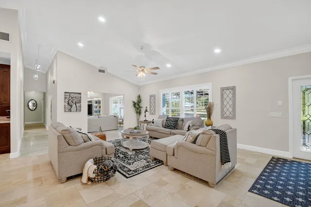 a kitchen with stainless steel appliances granite countertop a sink a stove and a refrigerator