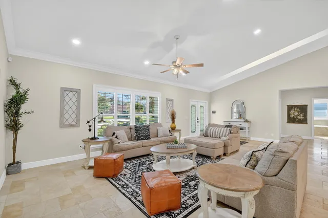 a kitchen with stainless steel appliances granite countertop a sink and a large window