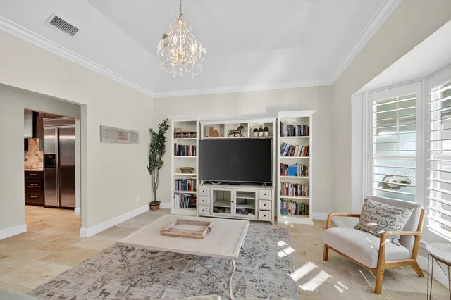 a dining room with furniture a chandelier and window