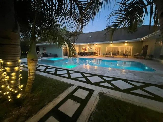 a view of a house with a yard and table and chair