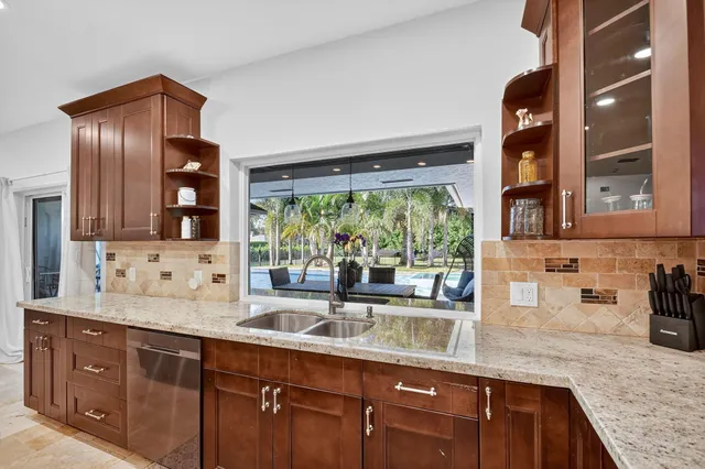 a bedroom with a bed a table chair and a chandelier