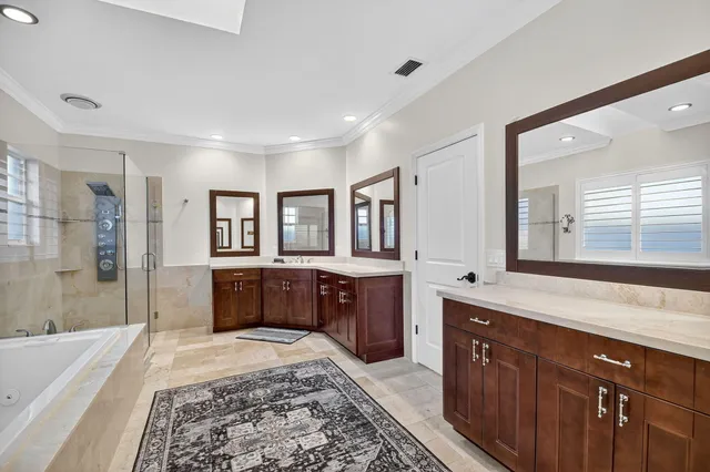 a patio with a table and chairs and potted plants