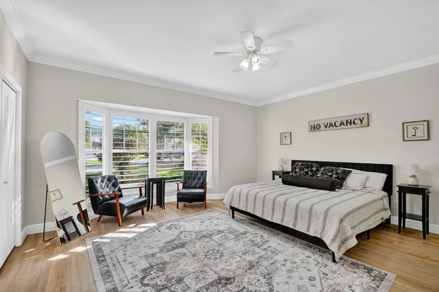 a dining room with furniture and a potted plant