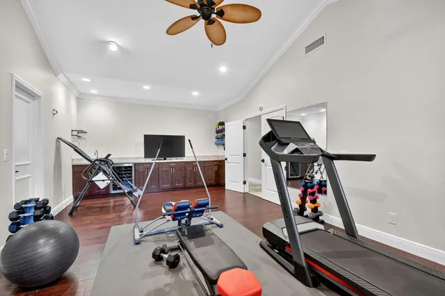 a view of a house with a yard and potted plants