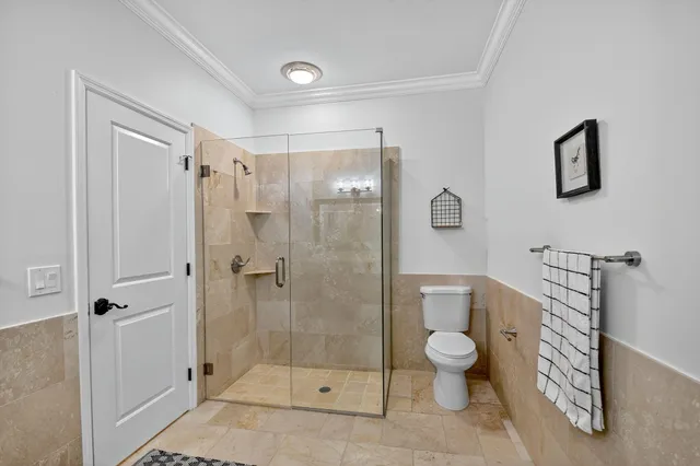 an aerial view of a house with a yard and lake view