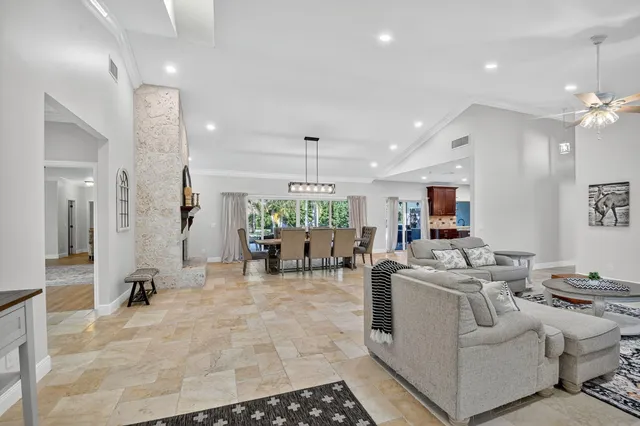 a living room with furniture a large window and a flat screen tv