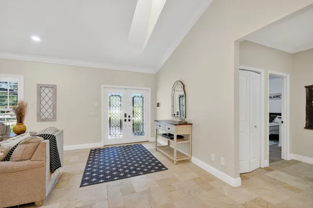 a living room with furniture a rug and a chandelier