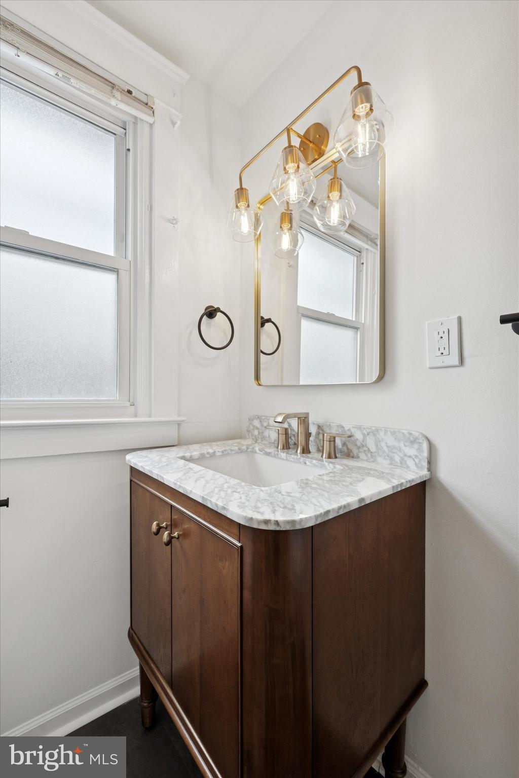 10 West Jefferson Street Media, PA 19063 - Photo 14 of 24 a bathroom with a granite countertop sink a mirror and a vanity