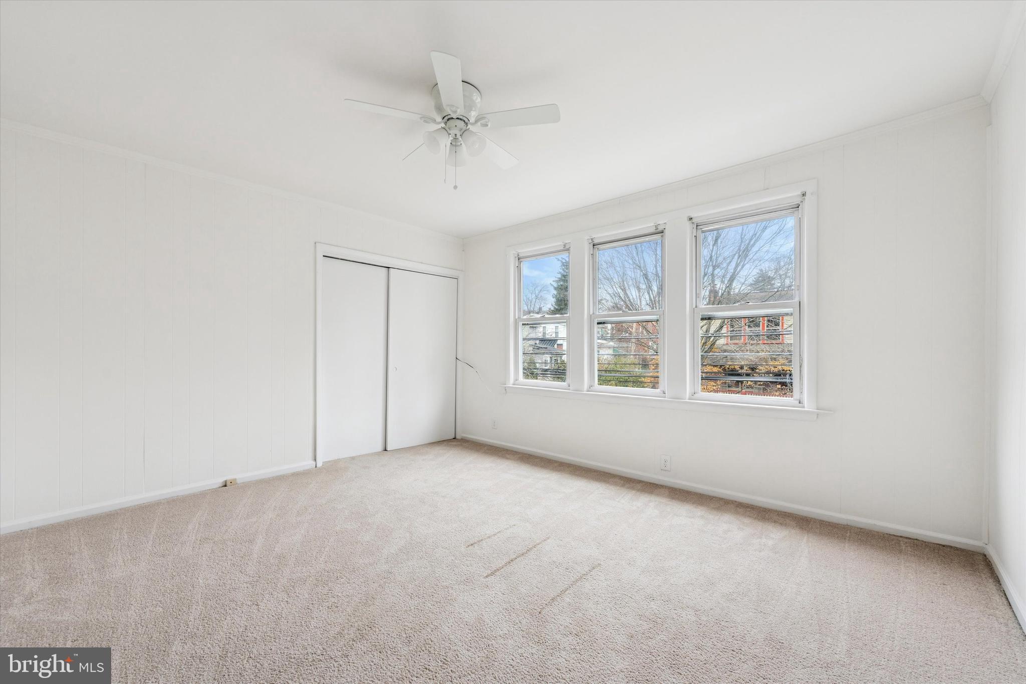 10 West Jefferson Street Media, PA 19063 - Photo 20 of 24 an empty room with windows and chandelier fan