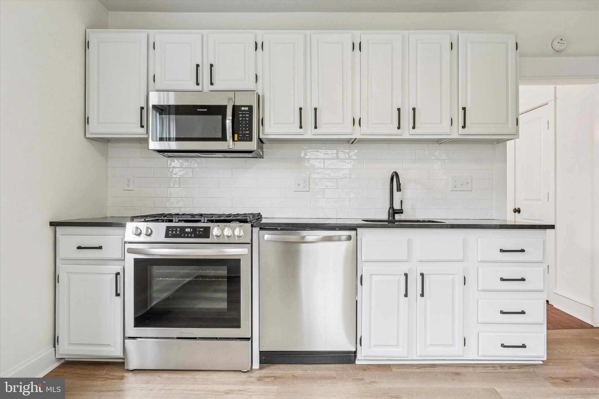 10 West Jefferson Street Media, PA 19063 - Photo 10 of 24 a kitchen with stainless steel appliances granite countertop a stove a microwave and cabinets