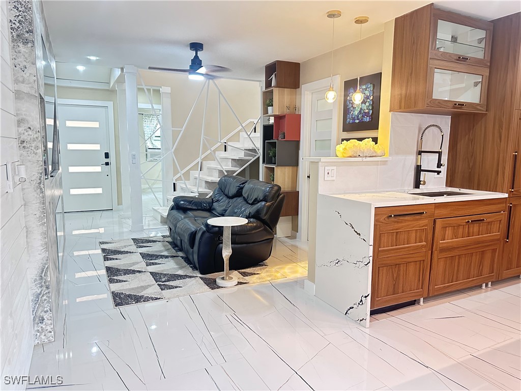 1107 1st Street South, Unit H Jacksonville Beach, FL 32250 - Photo 14 of 43 a hallway view with stainless steel appliances kitchen island granite countertop a refrigerator and a stove
