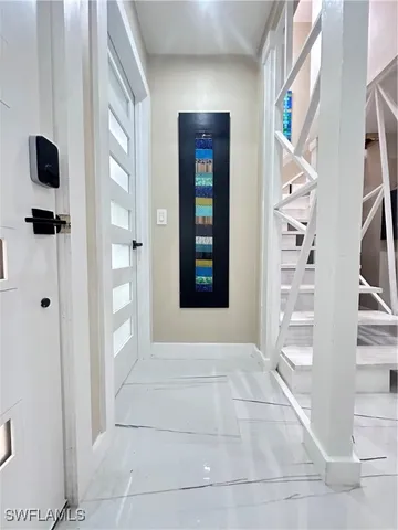 a view of an entryway with wooden floor and windows