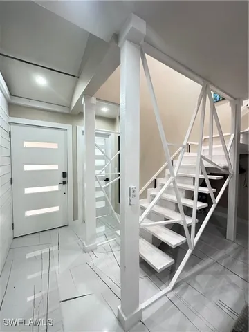 a view of entryway with wooden floor and front door