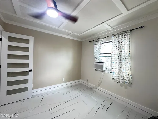 a view of empty room with window and stairs