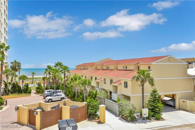 a view of a patio with couches and table and chairs and potted plants