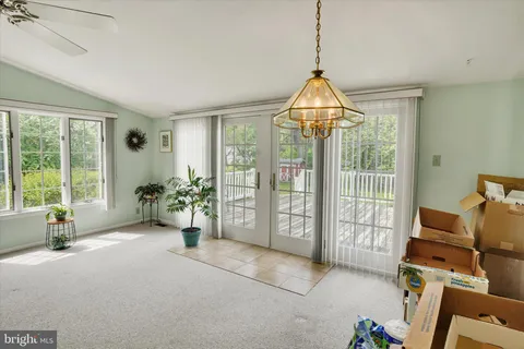 a living room with furniture and floor to ceiling window
