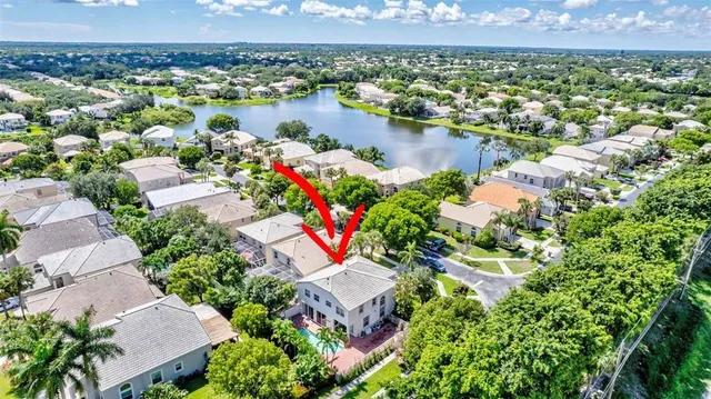 an aerial view of a house with a lake view