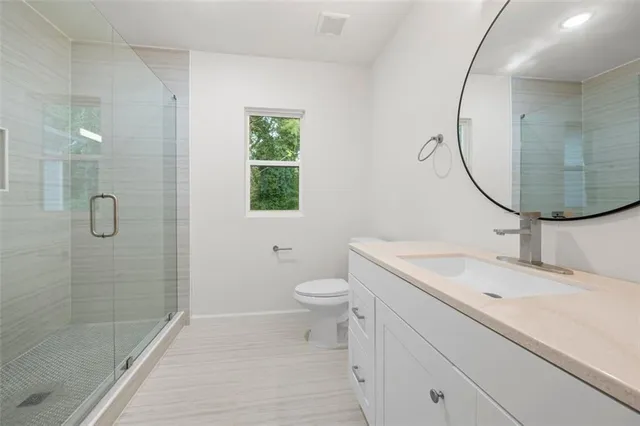 a large kitchen with a lot of counter space and wooden floor