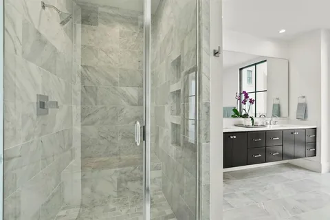 a spacious bathroom with a granite countertop sink a mirror a shower and a bathtub