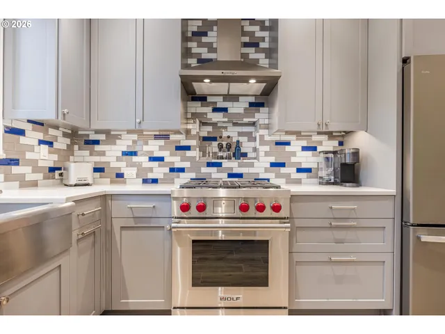 a kitchen with stainless steel appliances a stove and cabinets