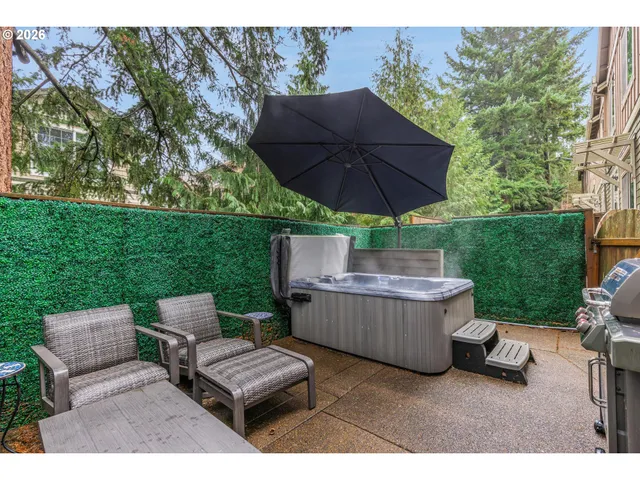 a view of backyard with outdoor seating and green space