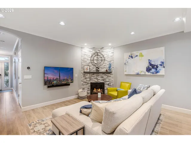 a living room with furniture a fireplace and a flat screen tv