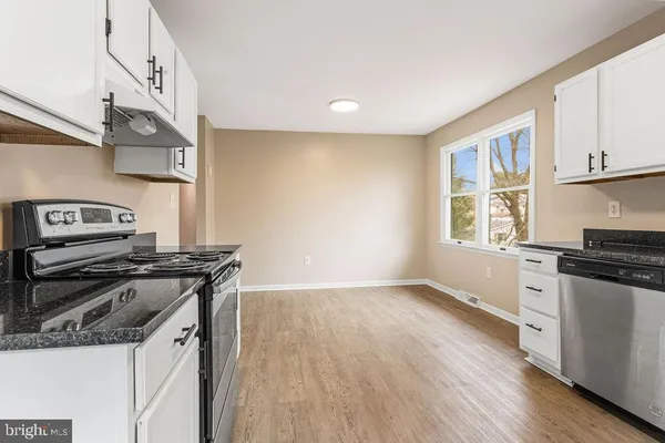 a kitchen with a stove and a microwave