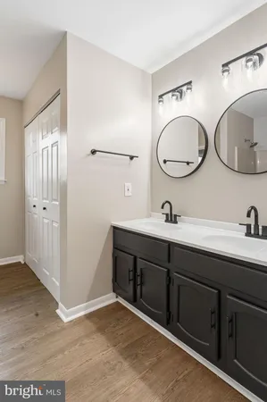 a bathroom with a double vanity sink and a mirror
