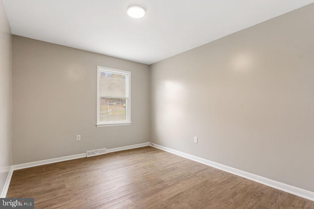 225 Bragg Circle Hanover, PA 17331 - Photo 20 of 32 an empty room with wooden floor and windows