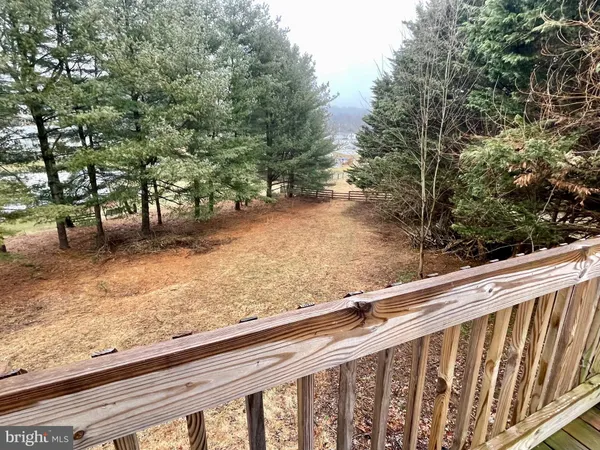 a view of a roof deck with wooden fence and floor