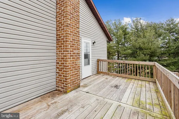 a view of a house with a wooden deck