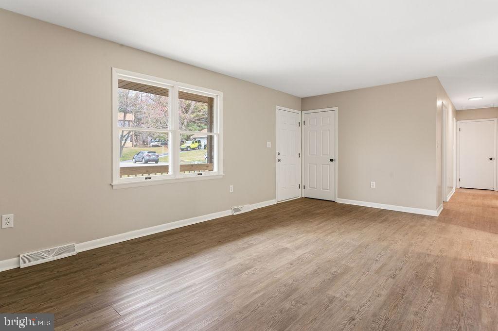 225 Bragg Circle Hanover, PA 17331 - Photo 7 of 32 a view of an empty room with wooden floor and a window