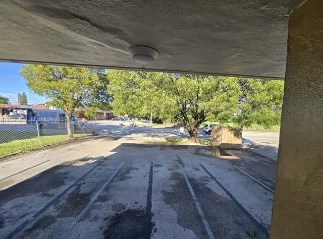 a kitchen with a sink cabinets stainless steel appliances and a window