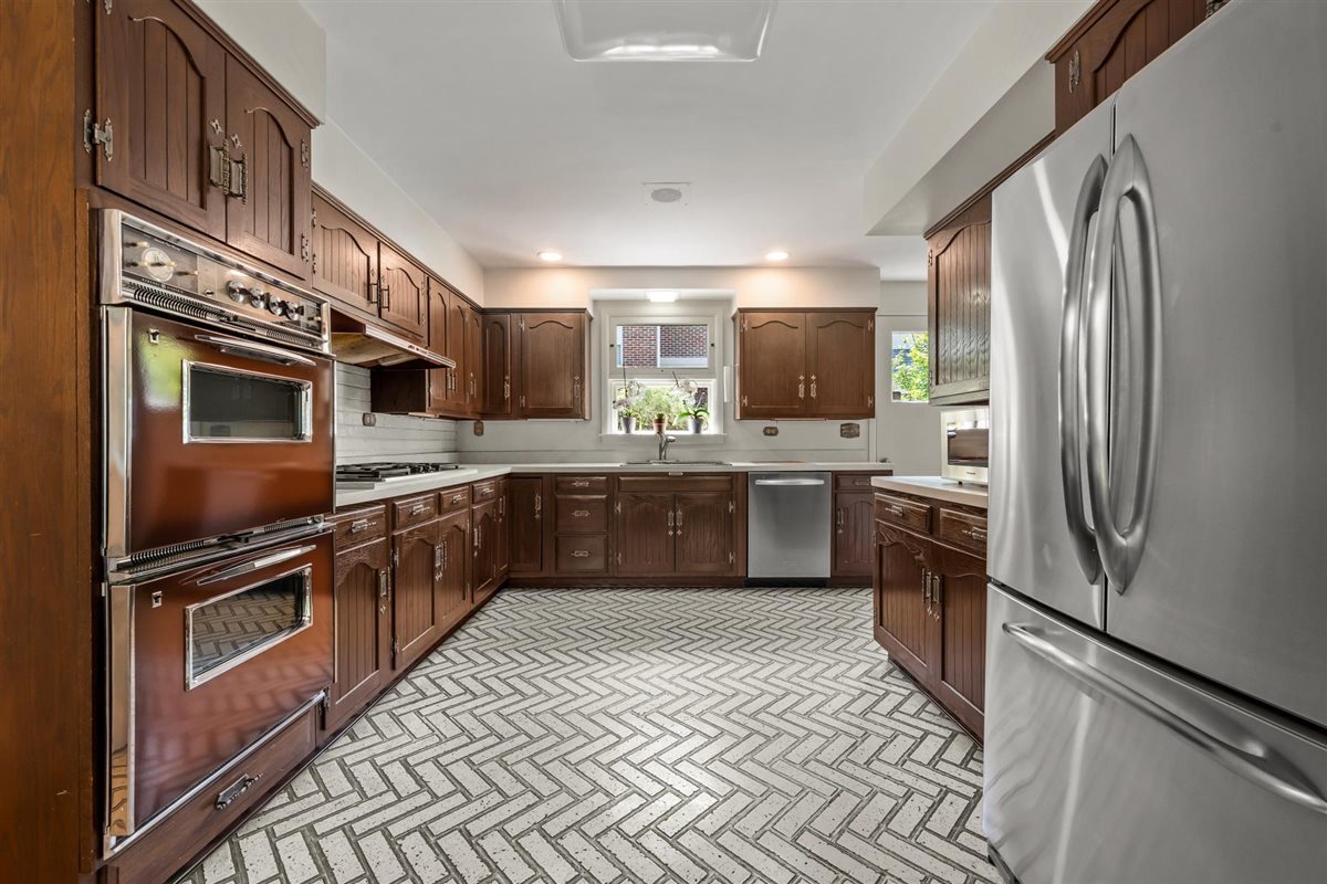 356 Sheridan Road Glencoe, IL 60022 - Photo 16 of 33 a kitchen with stainless steel appliances a sink dishwasher a refrigerator a stove top oven a washer and dryer
