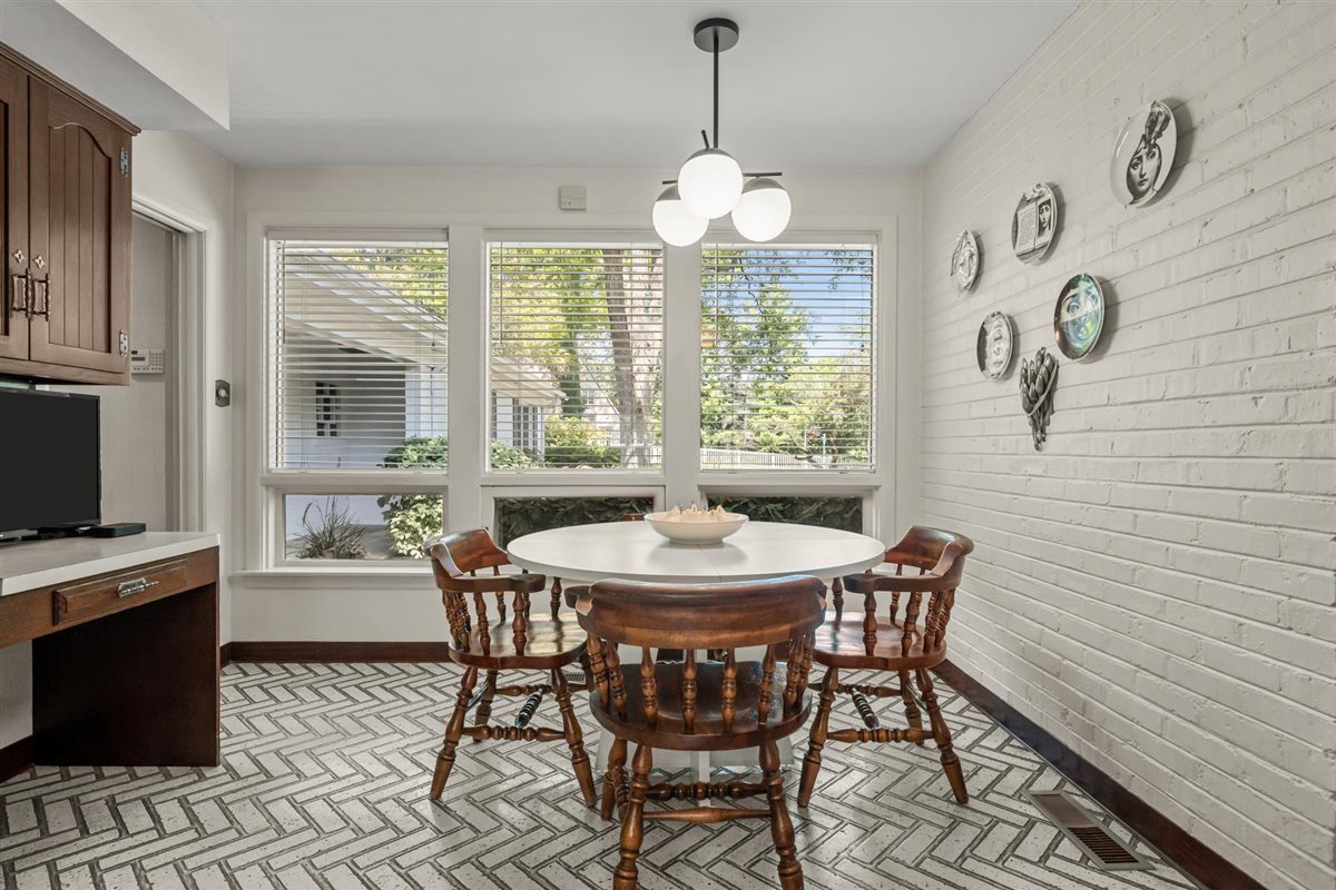 356 Sheridan Road Glencoe, IL 60022 - Photo 17 of 33 a dining room with wooden floor a chandelier a wooden table and chairs