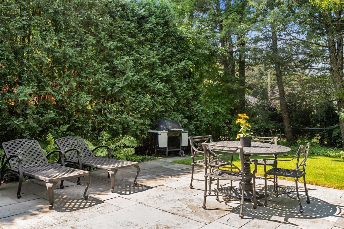 356 Sheridan Road Glencoe, IL 60022 - Photo 30 of 33 a view of a patio with a table and chairs under an umbrella