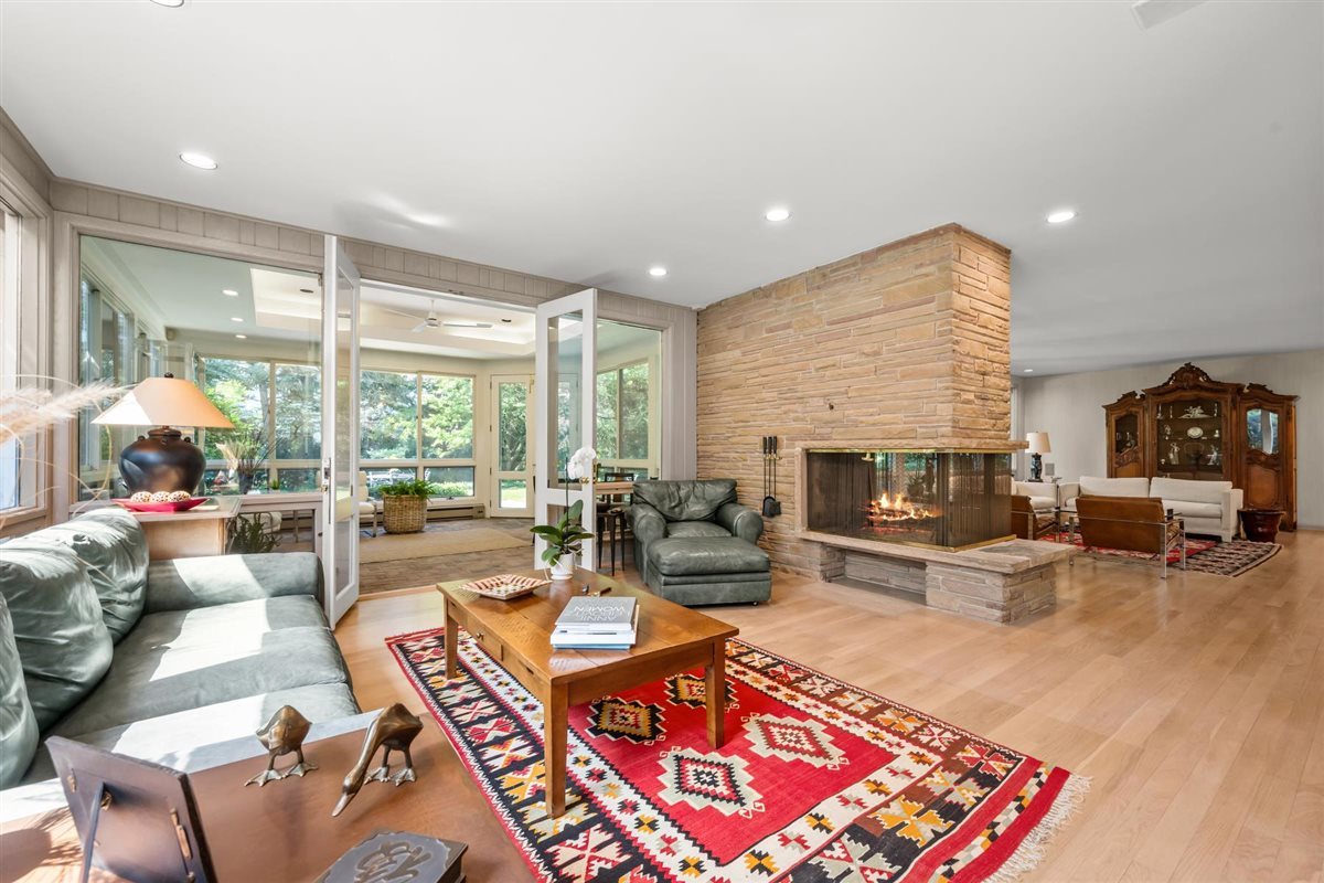 356 Sheridan Road Glencoe, IL 60022 - Photo 10 of 33 a living room with furniture a fireplace and a table