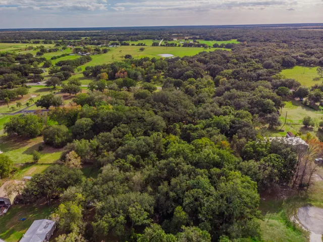 a view of a yard with wooden fence