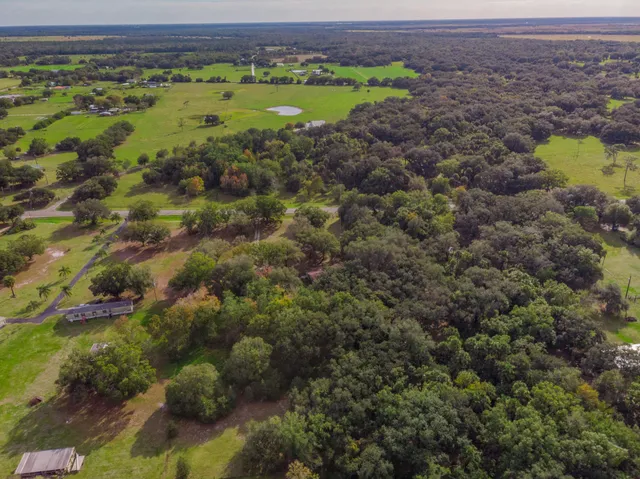 a view of outdoor space with green field and trees all around