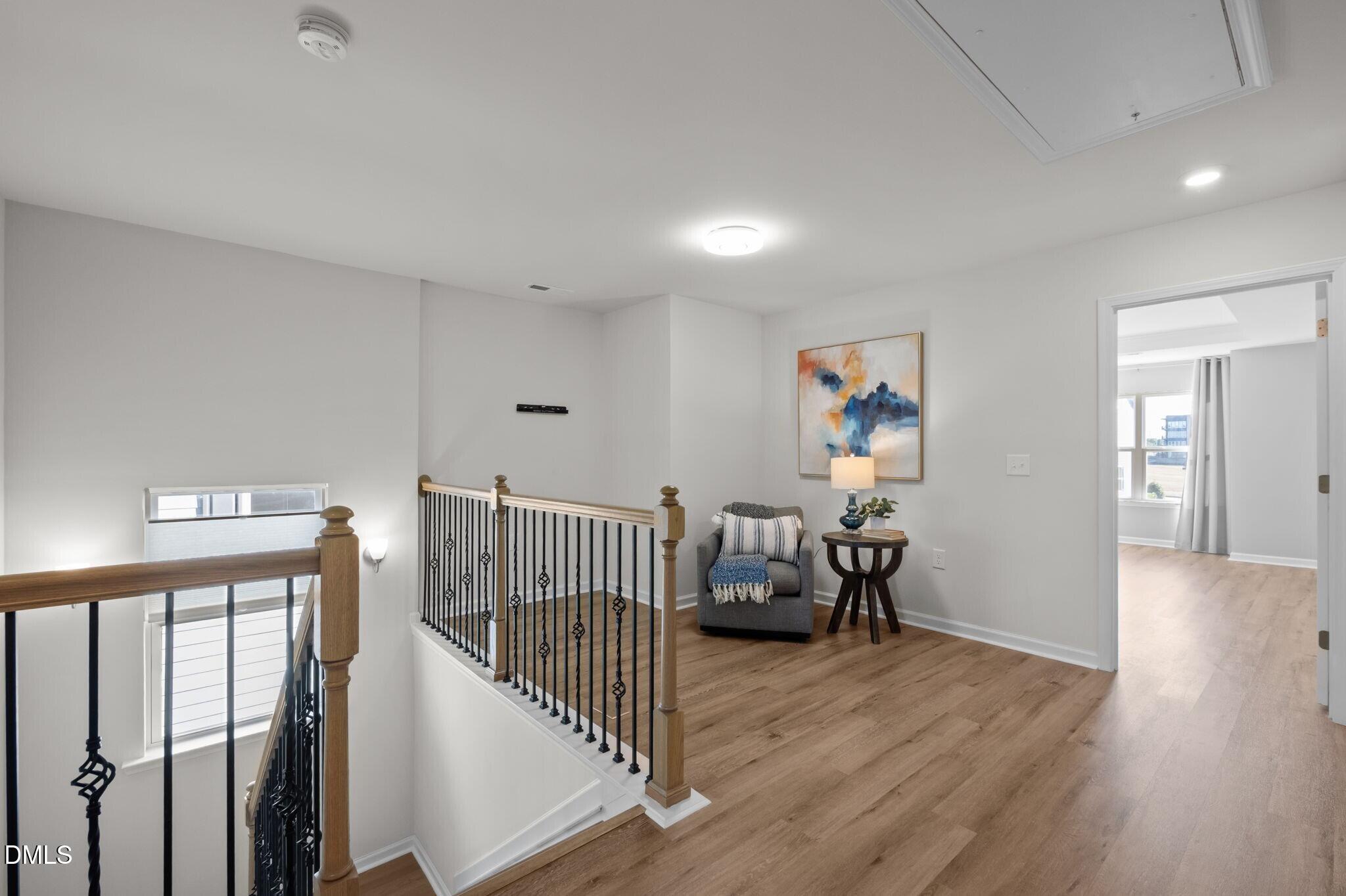 17 Rambler Lane Morrisville, NC 27560 - Photo 19 of 50 a view of a hallway with wooden floor and windows
